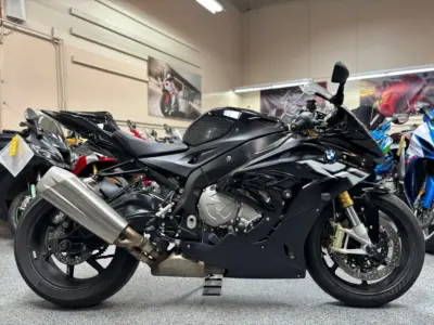 2015 BMW F800R 7 Black BMW S1000RR sport motorcycle side profile parked indoors with other bikes in background